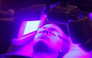 Client enjoying a Dermalux Tri-Wave MD LED Phototherapy treatment at SKIN lounge Aesthetics Richmond, using advanced LED light energy to boost collagen, reduce inflammation, and promote radiant skin.