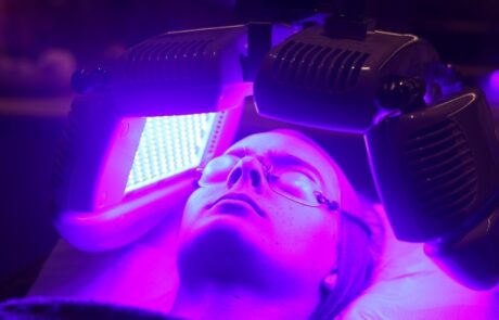 Client enjoying a Dermalux Tri-Wave MD LED Phototherapy treatment at SKIN lounge Aesthetics Richmond, using advanced LED light energy to boost collagen, reduce inflammation, and promote radiant skin.