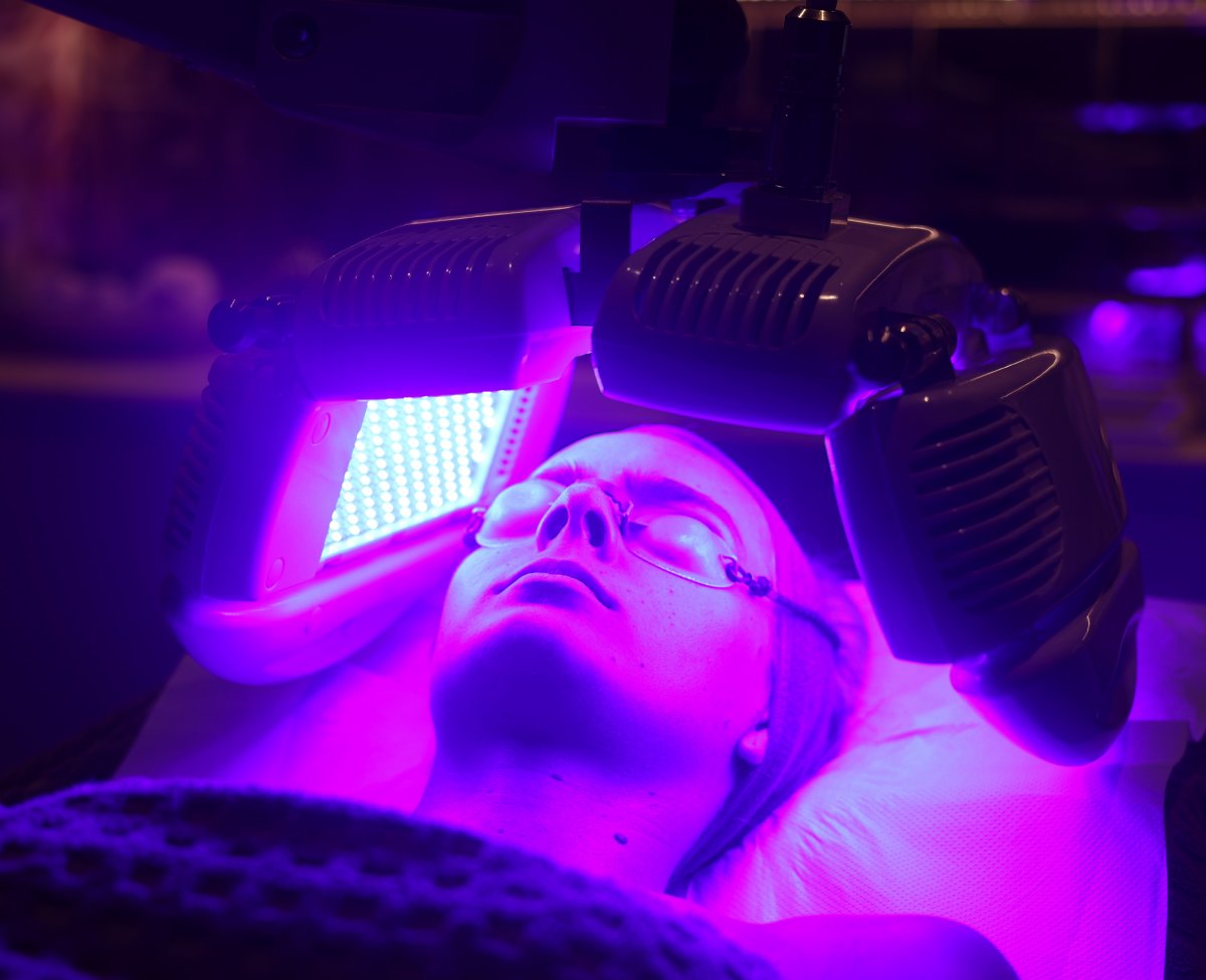 Client enjoying a Dermalux Tri-Wave MD LED Phototherapy treatment at SKIN lounge Aesthetics Richmond, using advanced LED light energy to boost collagen, reduce inflammation, and promote radiant skin.