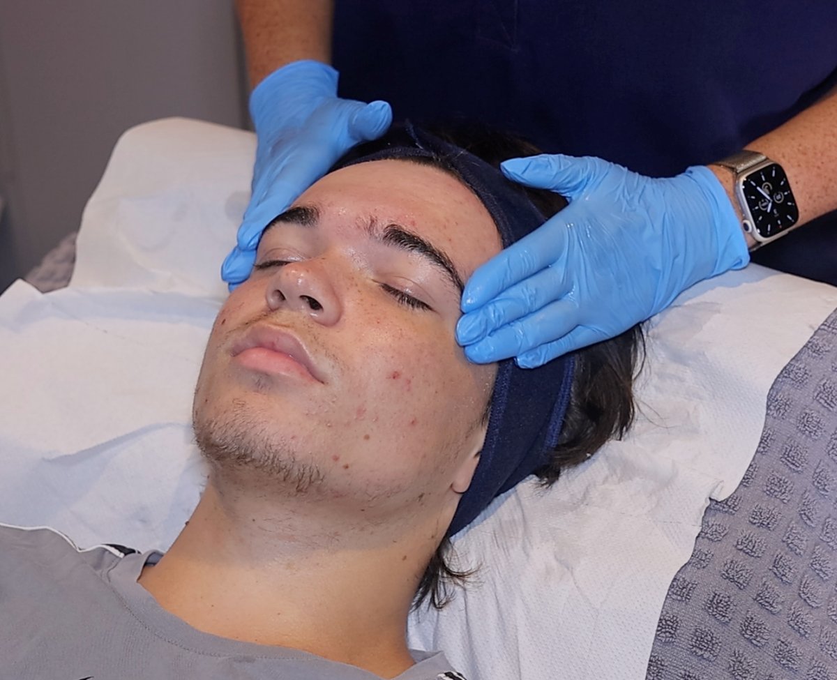 Client enjoying a HydraClean deep-cleansing facial at SKIN lounge Aesthetics Richmond Hill, an expert treatment combining professional techniques and targeted skincare to deeply cleanse, purify, and reduce acne, congestion, and scarring.