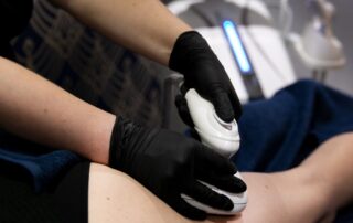 Client receiving T-Shape body sculpting and cellulite reduction treatment at SKIN lounge Aesthetics Richmond, using advanced multi-technology to firm, smooth, and contour the body. and encourages lymphatic drainage