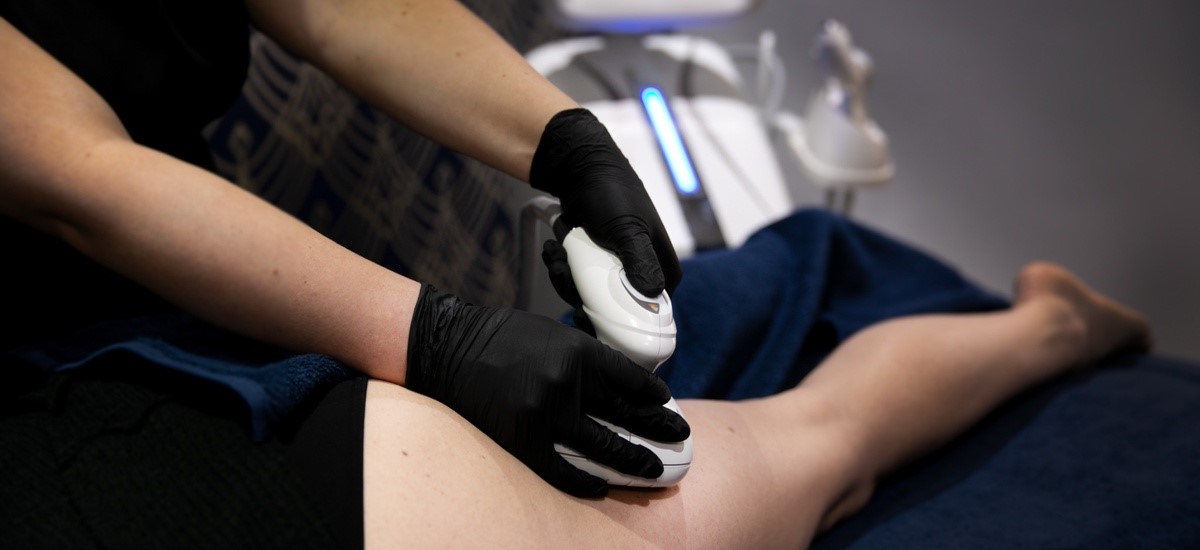 Client receiving T-Shape body sculpting and cellulite reduction treatment at SKIN lounge Aesthetics Richmond, using advanced multi-technology to firm, smooth, and contour the body.